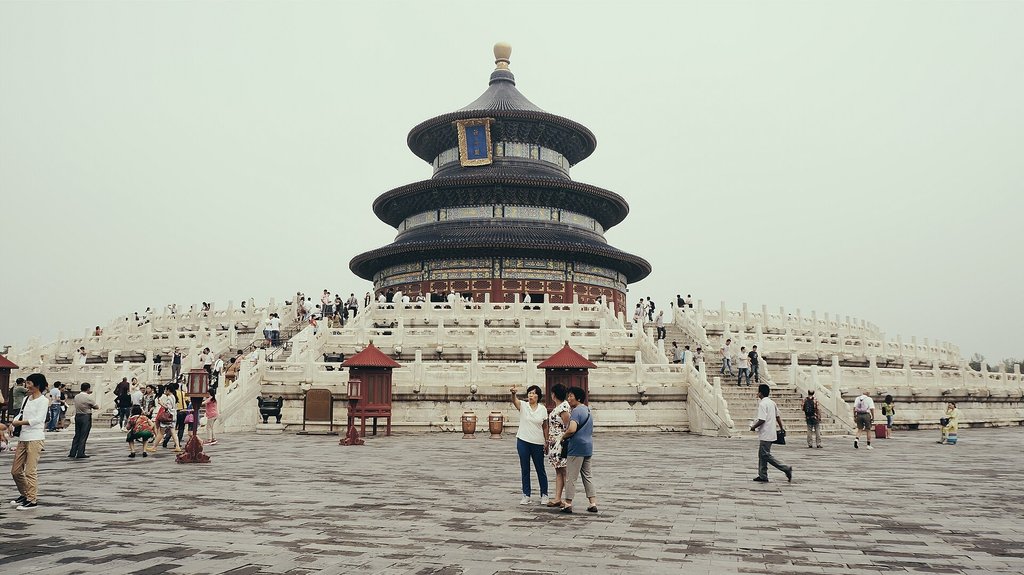 Temple of Heaven in Beijing with tourists walking across the plaza